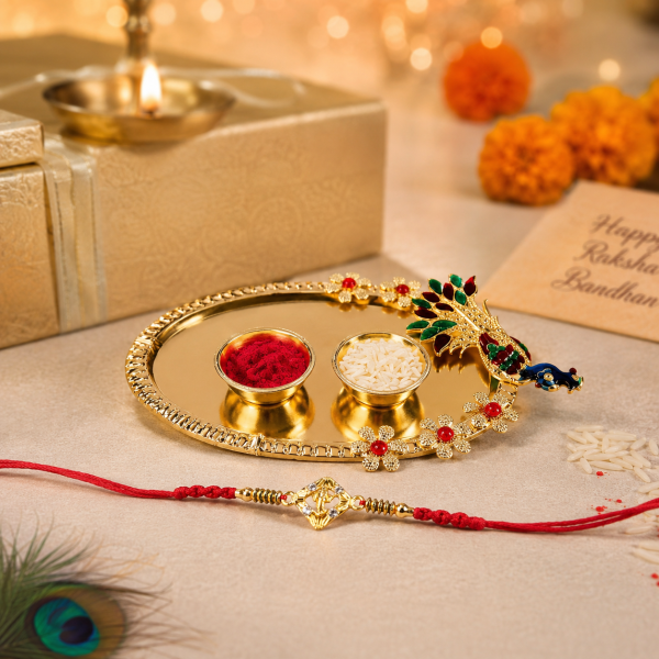 518c4df3-bb21-46a9-9c52-aa323a18ef62 Accessher Gold Plated Ganesha Rakhi - Gift Set with Acrylic Peacock Pooja Thali, Roli, Kumkum & Greeting Card