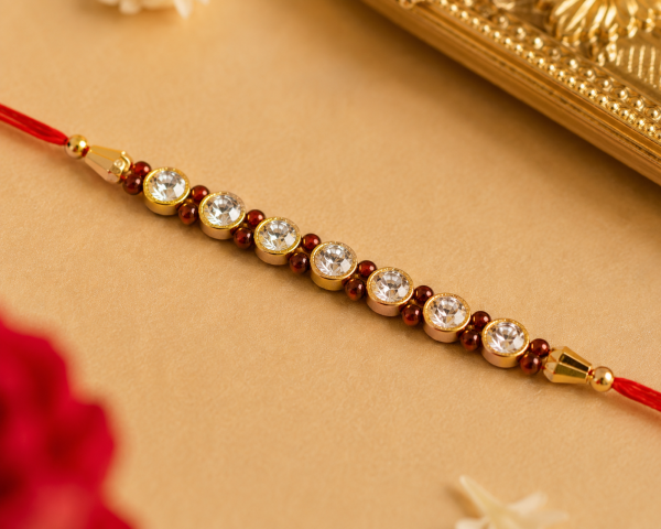ACCESSHER Elegant Pearl Studded Rakhi - Gift Set with Roli, Kumkum & Greeting Card