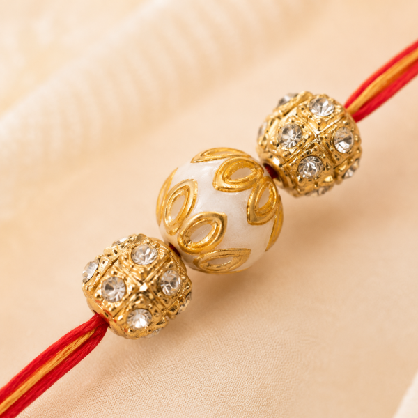 ACCESSHER Gold Plated Meenakari Pearl Rakhi - Gift Set with Roli, Kumkum & Greeting Card