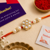 ACCESSHER Handmade White Floral Kundan Rakhi with Beads - Gift Set with Roli, Kumkum & Greeting Card